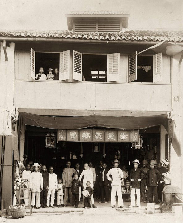 Yong Koon (with hand-on child's shoulder) in front of his first shop